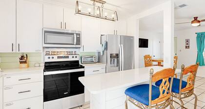First-floor condo with patio, grills, washer/dryer, streaming, kitchen, & AC
