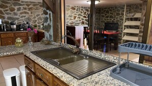 A kitchen with granite countertops, a sink, and a stone wall. - Villa with Private Pool and Douro Valley Views – 10 Minutes from Peso da Régua (Peso da Régua)
