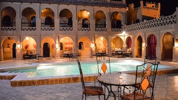 Outdoor pool, pool umbrellas, lifeguards on site