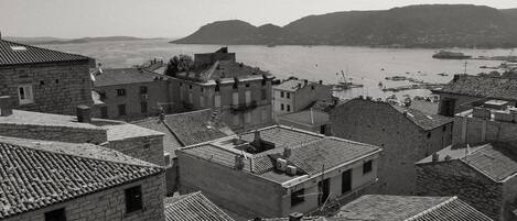 A coastal town with stone buildings and a harbor.