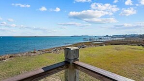 A coastal view with a wooden fence, grassy area, and a body of water. - OCEAN VIBES ON THE INTRACOASTAL (Wilmington)