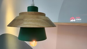 A pendant light with a wooden shade and a green base, hanging from a ceiling. - Ixora Coliving Lifestyle Homestay (Malacca City)