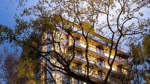 A multi-story hotel with a modern architectural design, featuring balconies on each floor and large windows. - Casa Joseph (Buenos Aires)