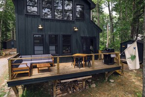 Deck with outdoor coach, eating area, and grill - Four-Season Luxury Lakefront Cabin Close to Camden and Rockland (Hope)