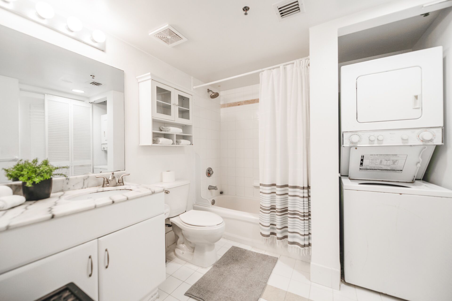 A modern bathroom with a toilet, sink, and shower area.