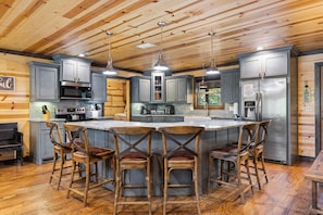 Enjoy cooking in this well-equipped kitchen with a central island and bar stools.