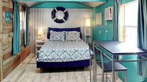 A room with a bed, a desk, and a window. - Sand Piper by Miss Kitty’s (Rockport)
