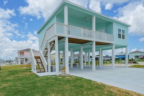 Stunning two-story home with a covered porch and beautifully manicured lawns.