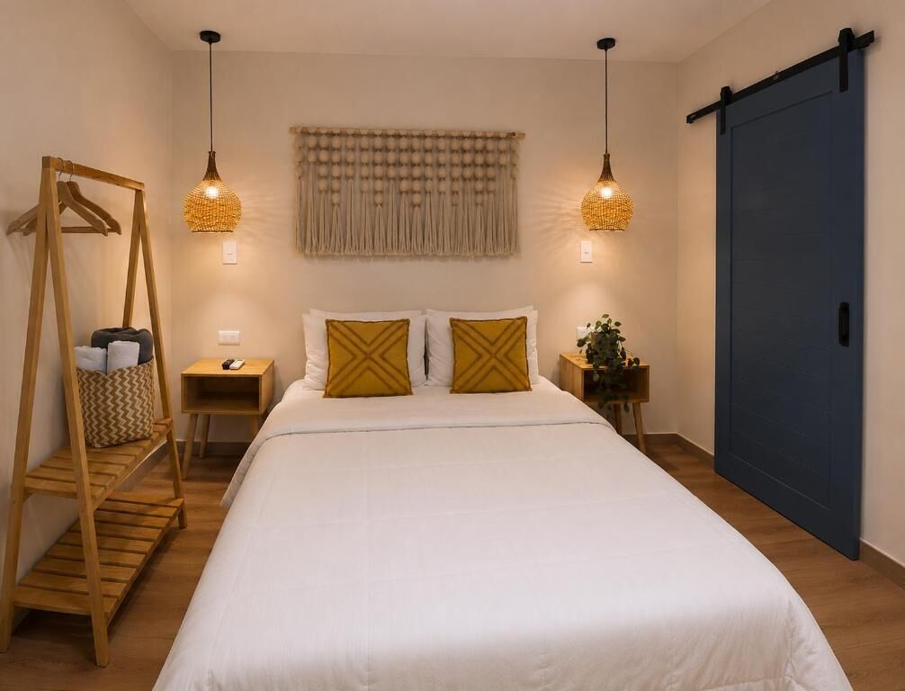 A bedroom with a bed, bedside tables, a wardrobe, and a hanging light fixture.