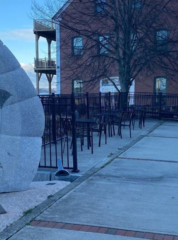 Relax in the outdoor seating area with comfortable chairs and a unique stone feature.