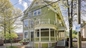 A two-story house with a front porch and a covered front yard. - Beautiful Providence Apt Near Dtwn & Federal Hill! (Providence)