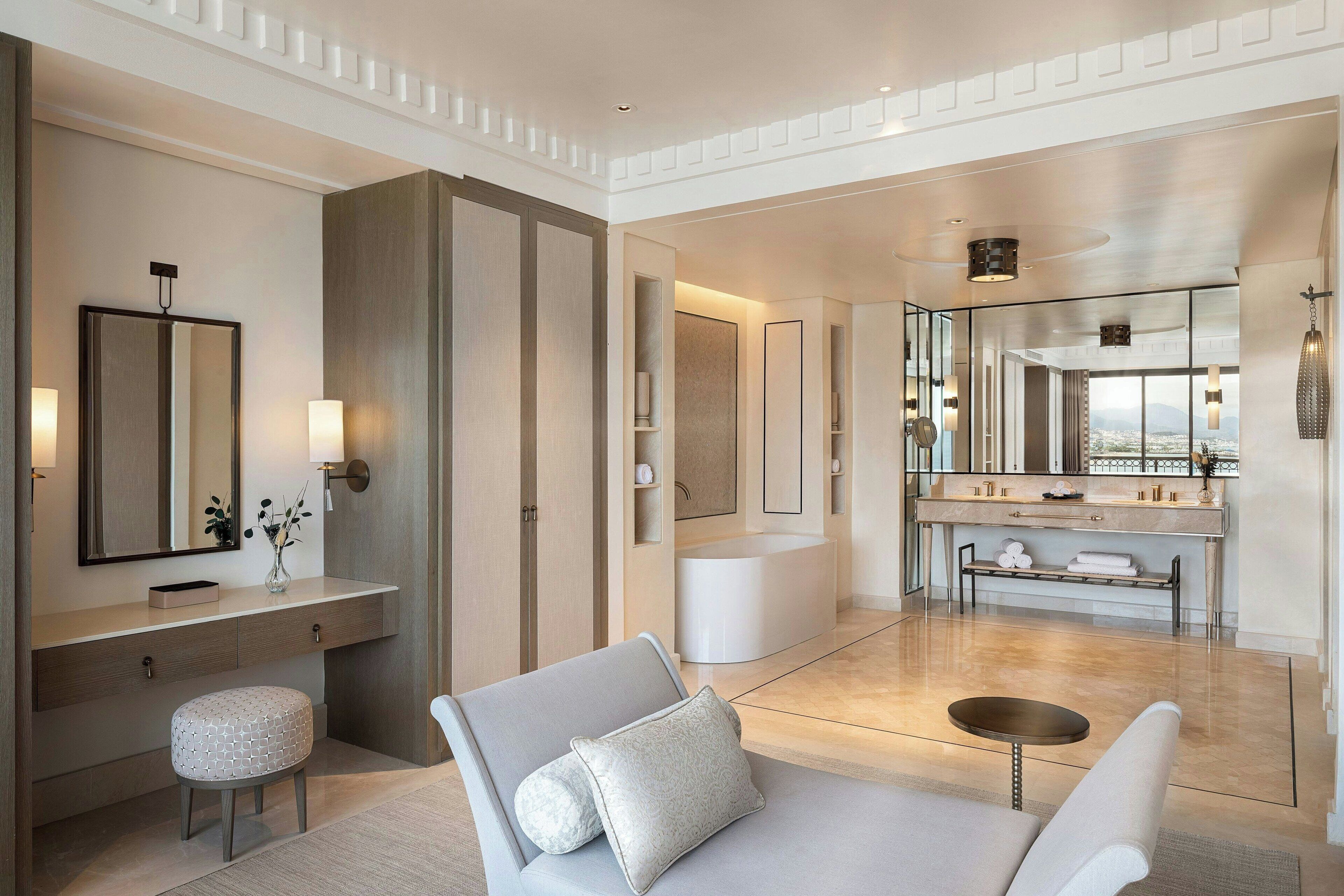 A modern bathroom with a vanity, mirror, and bathtub.