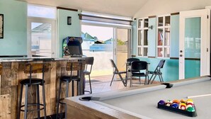 A pool table with stools, a bar area, and a view of the outside. - #25 5,000 SqFt Penthouse w/ Private Rooftop Loft (Cabo Rojo)