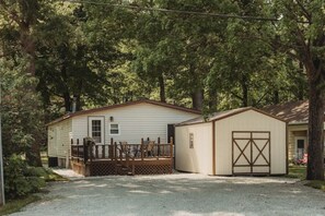 A single-story house with a porch, a garage, and a fenced yard. - Mooseyard Lodge (Shawano)