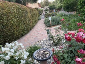 Stroll along the beautifully maintained garden pathway, lined with a variety of plants and flowers, and enjoy a peaceful atmosphere.