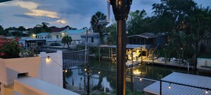 Waterfront property with a garden, dock, and multiple buildings, offering outdoor seating areas and a serene atmosphere.