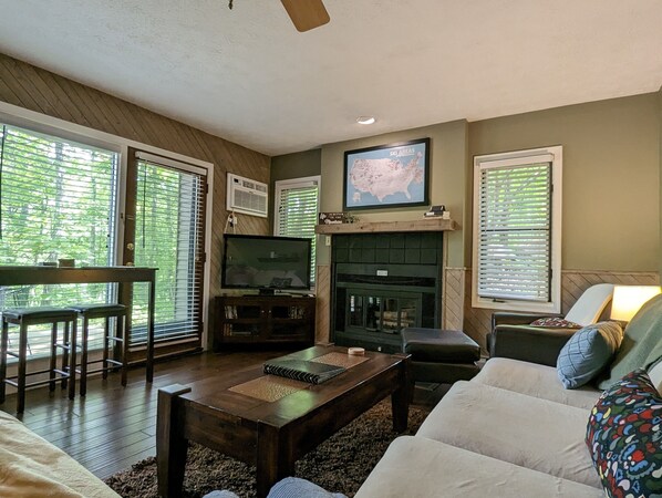 A living room with a fireplace, a television, and a sofa.