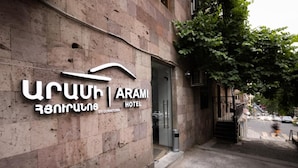 A hotel sign with the name "Urartu Arami Hotel" and a staircase leading to the entrance.