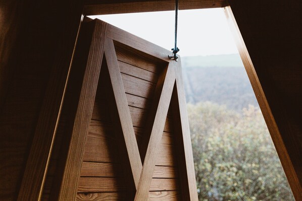 A wooden structure with a triangular design, possibly part of a building's architecture.