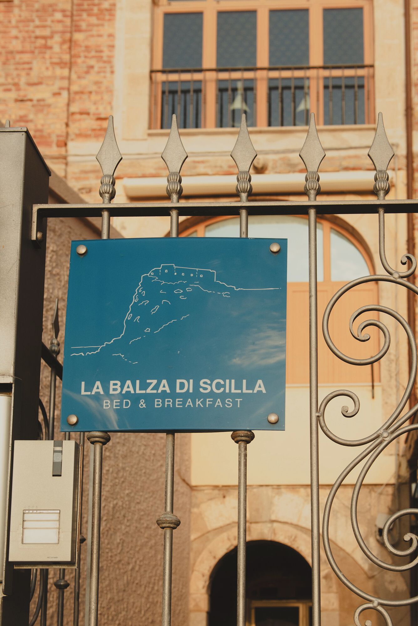 A sign for 'LA BALZA DI SCILLA BED & BREAKFAST' with a map outline.