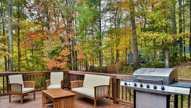 A deck with outdoor furniture and a portable grill. - Forest Run - 4 Bedrooms with hot tub (Asheville)