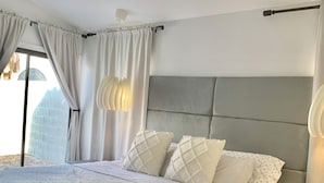A bedroom with a bed, a nightstand, a ceiling fan, and a window with curtains. - Cortaro Sweet Home-Quiet gated community  (Tucson)