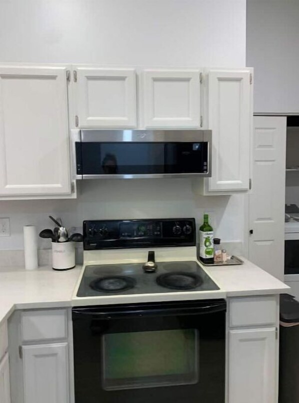 Effortlessly cook up a meal in this well-equipped kitchen with a digital stove and ample countertop space.
