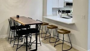 A modern kitchen with white cabinets and a wooden countertop. - Cortaro Sweet Home-Quiet gated community  (Tucson)
