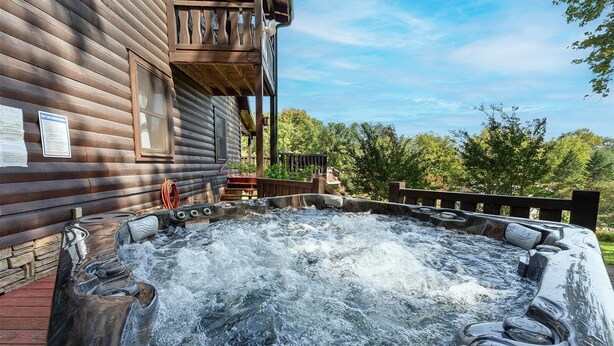 A wooden cabin with a hot tub in front. - Burning Tree: Pet Friendly, Free Attraction Tickets, Hot Tub, Mtn View & Close to SKY MTN Park (Sevierville)