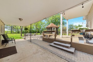 A covered patio with outdoor furniture, a small gazebo, and a brick pathway. - Spacious and family friendly getaway. 8 mins from Chicago Premium Outlet Mall.  (Aurora)