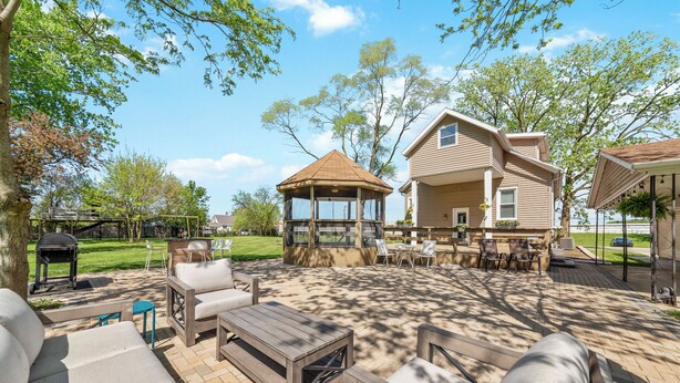 A patio area with outdoor furniture, a gazebo, and a barbecue grill.