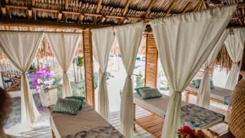 Relax in a serene outdoor space with comfortable seating and a potted plant.