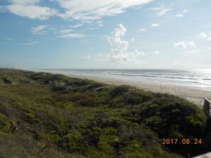 Enjoy a serene beachside escape with access to the sandy beach and grassy dunes.