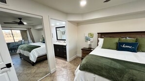 A hotel room with a bed, a bathroom, and a balcony. - Beach Front Condo In Beautiful Lake Havasu Arizona (Lake Havasu City)