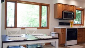 Una cocina moderna con armarios de madera, un microondas y una estufa.