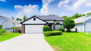 A single-story house with a garage, a front yard, and a driveway.