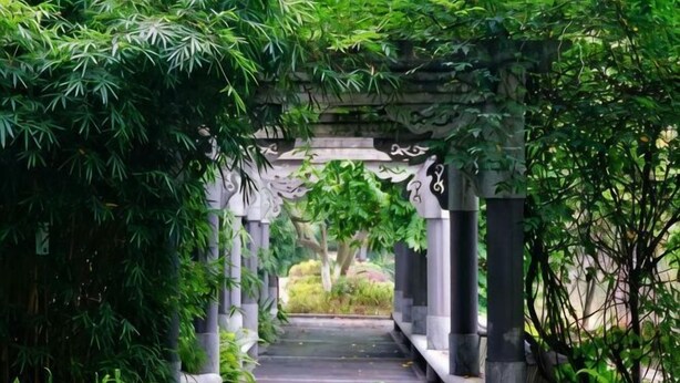A stone archway with intricate carvings, surrounded by lush greenery. - Laiya Boutique Hotel (Southwest University Zhuangyuanbei Subway Station) (Chongqing)