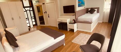 Triple Room - Balcony and Partial Seaview | Minibar, individually decorated, individually furnished, desk