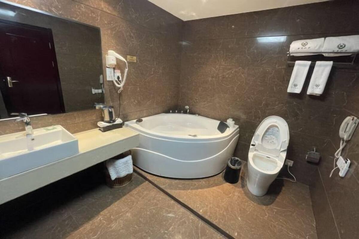 A modern bathroom with a freestanding bathtub, a toilet, and a sink.