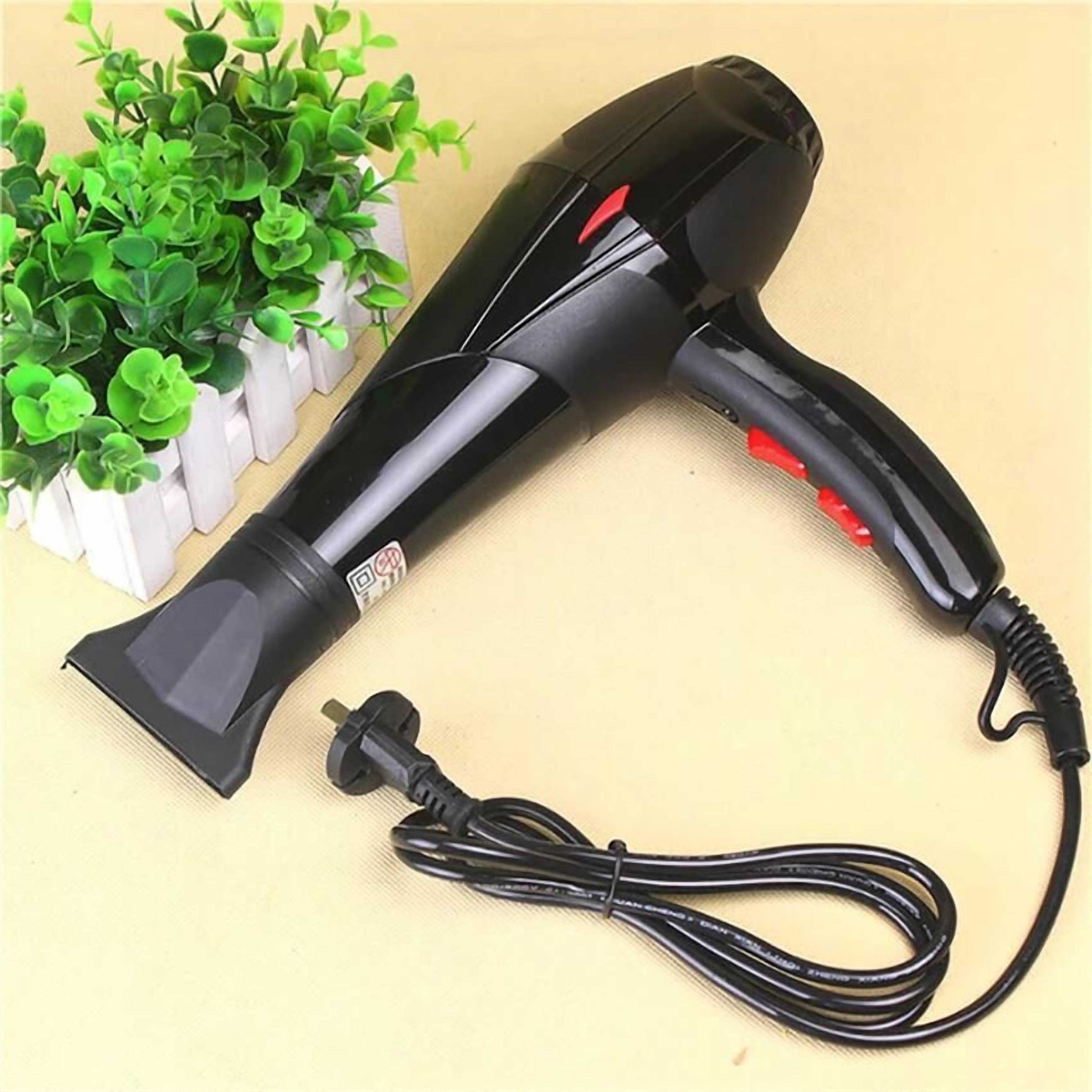 A black hair dryer with a red accent and a power cord.