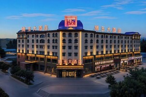 A large hotel with a prominent entrance and multiple floors.