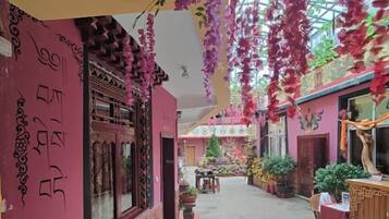 An indoor corridor with traditional architecture, including wooden doors and decorative elements.