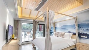 A bedroom with a canopy bed, a TV, a desk, and a mural of mountains. - Lanhu Xiaozhu Hostel (Suzhou)