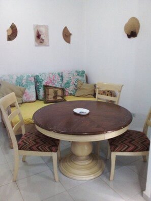Enjoy meals in this cozy dining area with a round table and comfortable seating for four.