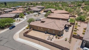 A residential area with houses featuring red-tiled roofs, a central driveway, and a mountain backdrop. - Design Dream / View / 4 BR 3 BA / Upscale / Garage (Sahuarita)