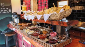 A buffet with various food items and a coffee machine.