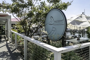A sign for 'The Point Crab House & Grill' with outdoor seating and a view of water. - Cool Spring waterfront apartment with pier mins to Annapolis (Arnold)