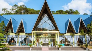 A modern building with a triangular roof and large glass windows. - Tea Resort Prenn (Xuan Huong - Da Lat)