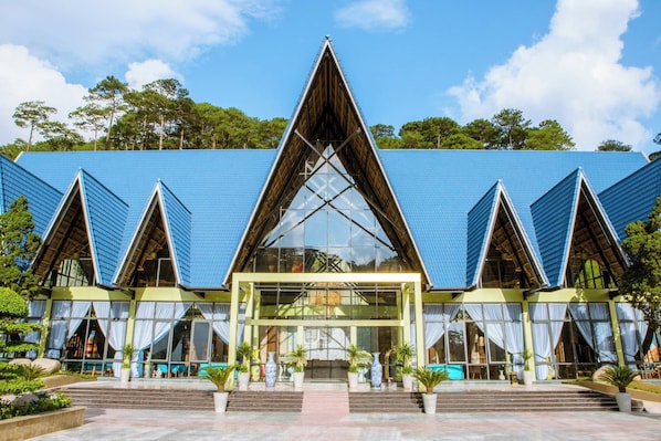 A modern building with a triangular roof and large glass windows.