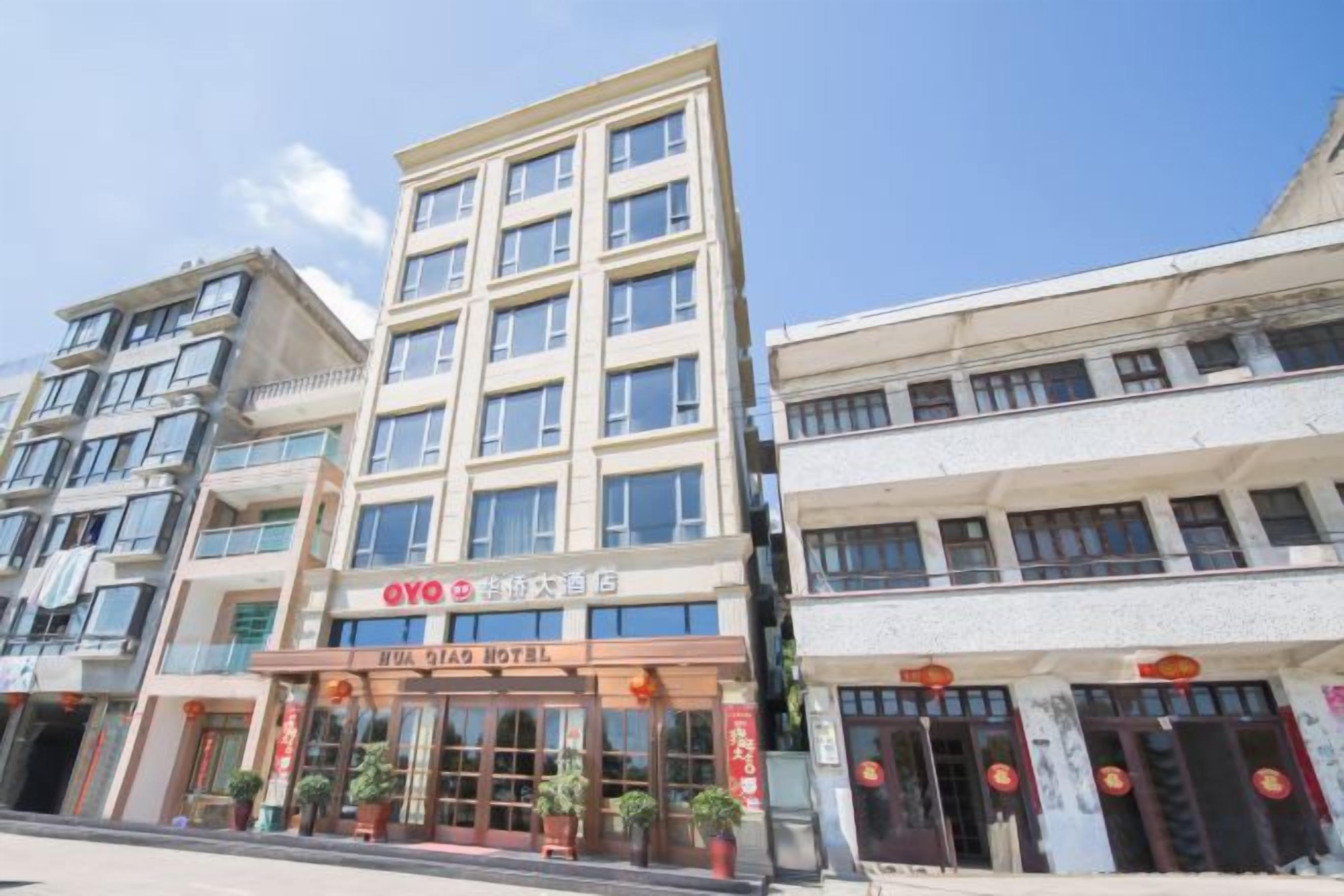 A hotel with multiple floors, a visible entrance, and a sign indicating it is a hotel.